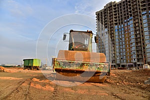 Soil Compactor leveling ground at construction site. Vibration single-cylinder road roller on construction road. Road work and