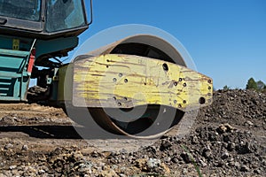 Soil Compactor, single drum road roller at the construction site of a highway.