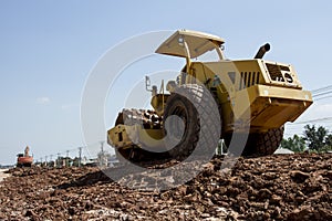 The soil compactor is in the work area.Road roller equipped with padfoot drum