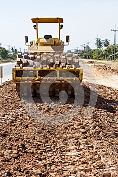 The soil compactor is in the work area.Road roller equipped with padfoot drum