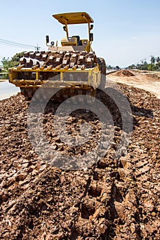 The soil compactor is in the work area.Road roller equipped with padfoot drum