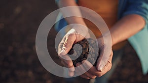 soil in the hands of the farmer. agriculture. close-up of a farmers hands holding black soil in their hands, fertile