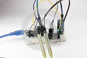 Soil moisture sensor with some breadboard circuit using a programmable micro controller. Digital soil moisture meter project