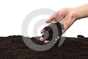 Soil is pouring from a woman`s hand.