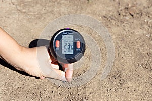 Soil temperature, moisture content, environmental humidity and illumination measurement. Global warming concept.
