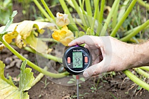 Soil test - measuring temperature and moisture content. Greenhouse effect and global warming concept
