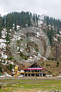 Solang, Himachal Pradesh, India-April 16th, 2015: Colorful entrance building of ski club and rope-way starting location with snow