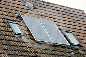 Solar battery on the tiled roof of the city house