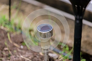 Solar cell lamp in garden. solar cell panel on lanterns for the garden on a green glade. solar panels Installed on Light poles in