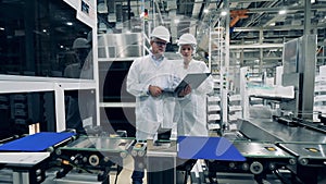 Solar cells production process with two experts observing it