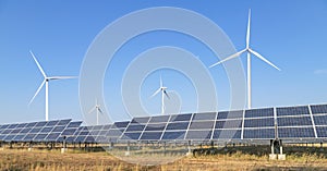 Solar cells or solar panels or photovoltaic cells with wind turbines generating electricity alternative renewable wind energy and