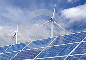 Solar cells with wind turbines generating electricity in hybrid power plant systems station on blue sky background