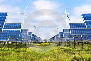 Solar cells and wind turbines generating electricity in power station alternative renewable energy