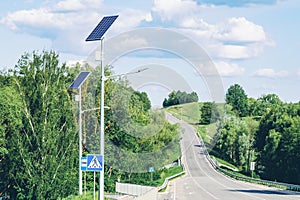 Solar device with street lamp on background of blue sky. Street light powered by solar panel with battery included. Alternative