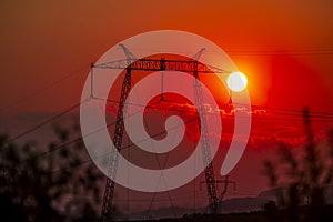 Solar dish on the elctric pylon at the sunset