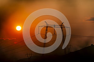 Solar dish on the elctric pylon at the sunset