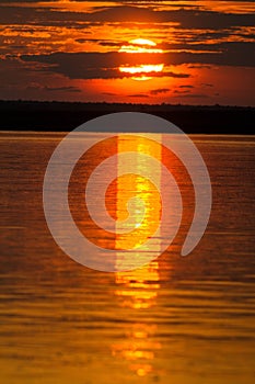 The solar disk falls over the horizon line.