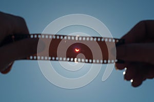 A solar Eclipse, the hand holding exposed film,