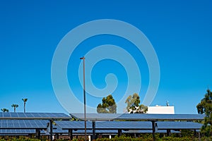 Solar electric panels on bright blue sky. Photovoltaics PV outdoors. Mounted solar arrays