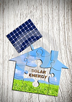 Solar energy concept, puzzle house with solar battery