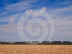 Solar farm on red soil against blue sky in Castile La Mancha, Spain. photo