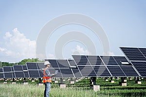 The solar farm(solar panel) with engineers check the operation of the system.
