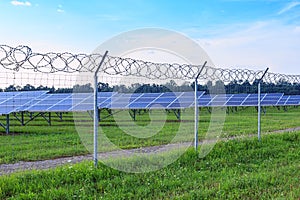 Solar panel on blue sky background. Green grass and cloudy sky.