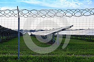 Solar panel on blue sky background. Green grass and cloudy sky.