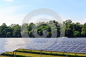 Solar panel on blue sky background. Green grass and cloudy sky.