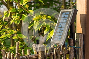 Solar panel in the garden, providing three led-lights with energy