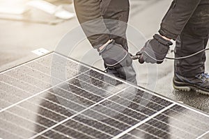 The solar panel installer connects the modules together using an electrical cable or plug wire. Mounting work on the