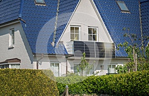 Solar panel in modern balcony of residential home with sunlight reflection.