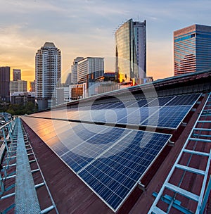 Solar Panel Photovoltaic installation on a Roof of factory, sunny blue sky background, alternative electricity source - photo