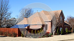 A Solar Panel powers a Middle Class Suburban Home photo