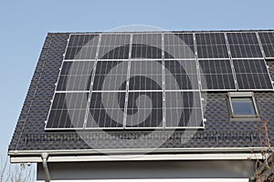 Solar panel on a red roof. House with solar panels on the roof photo