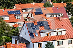 Solar panel on red tiled roof, alternative energy source for home