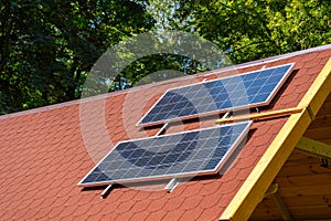 Solar panel on the roof of the house. Red tiles.