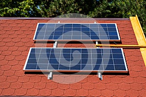 Solar panel on the roof of the house. Red tiles.