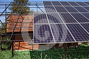 A solar panel on the roof on old wooden house at mountain countryside, green energy