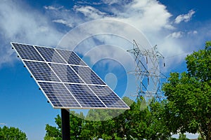 Solar Panel on a Sunny Day with High Tension Voltage Power Lines