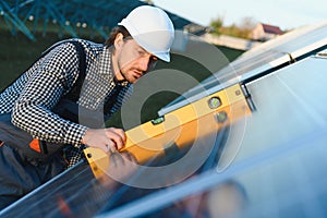 Solar panel technician installing solar panels on a sunny day