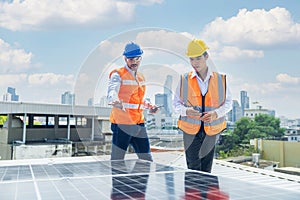 Solar panel technician on roof. Engineer and Young technician installing solar panels on factory roof