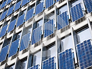 Solar Panel wall on Building Facade clean Energy Industrial utility system Technology background