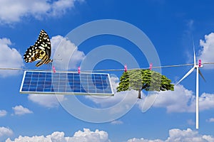 Solar panel and wind turbine and tree hanging on clothes line with butterfly