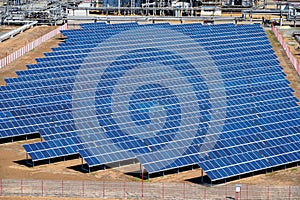 Solar panels on the background of a smokestack at a refinery in RussiaPanorama of the oil refinery. Oil refinery in Russia.