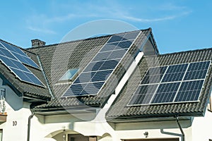 Solar panels on the black roof of a single family house