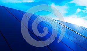 Solar panels on blue sky background. Photovoltaic cells of solar panel generating clean energy from the sun. Renewable