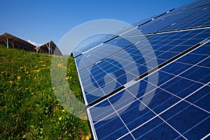 Solar panels, blue sky and green grass