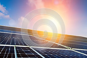 solar panels on business roof with sun in background golden hour