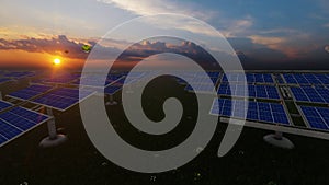 Solar Panels Farm and Hot Air Balloons rising in the distance against beautiful sunrise, 4K